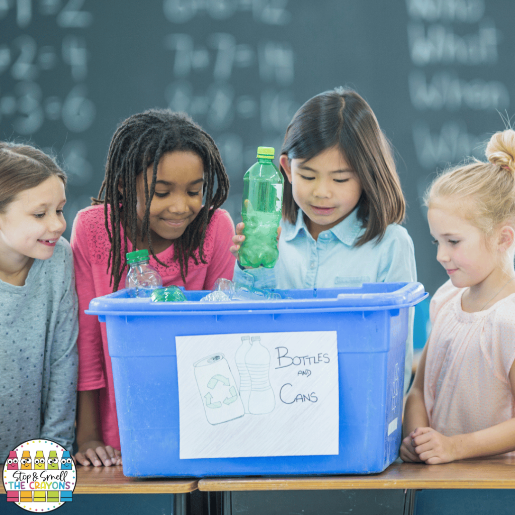 This image shows a group of young students working on recycling in their classroom.